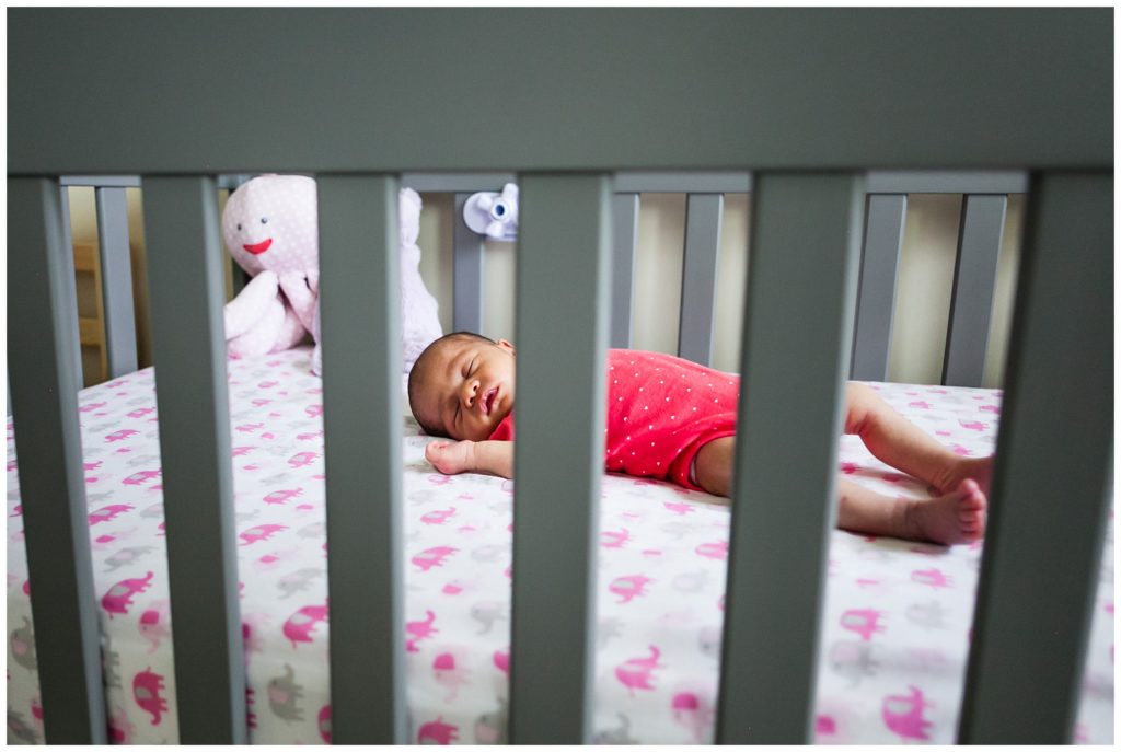 Newborn baby asleep in crib