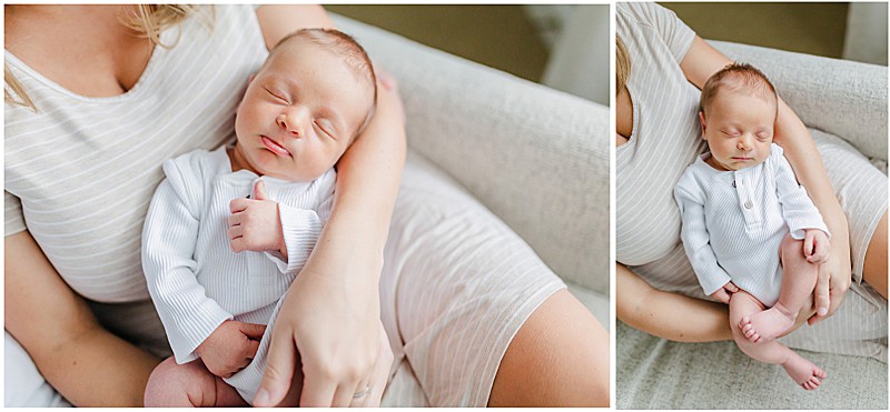 Sleeping newborn in a onesie being held by mother